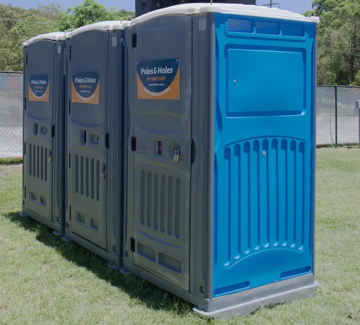 Poles and Holes branded portable toilets on site