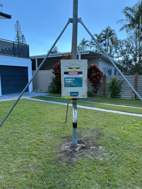 A Poles and Holes temporary builder's power pole installed with metal stays on a South East Queensland construction site