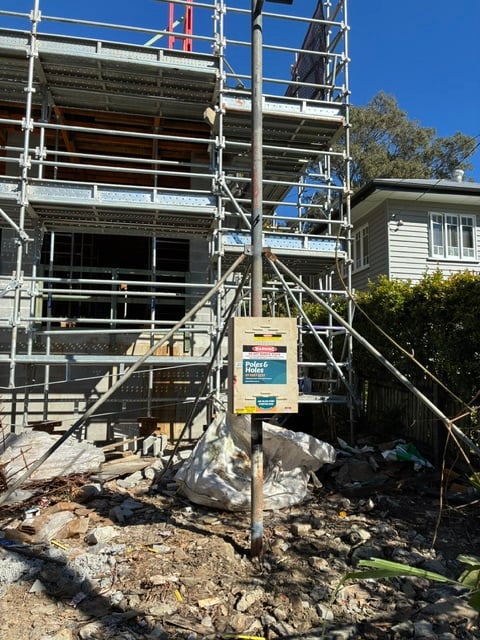 A Poles and Holes temporary builder's power pole installed with metal stays on a South East Queensland construction site
